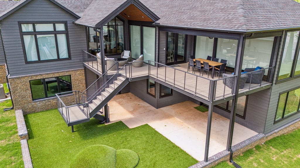 Modern home with large windows and turf for pets