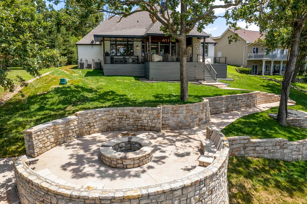 Modern back yard with large fire pit area after remodel