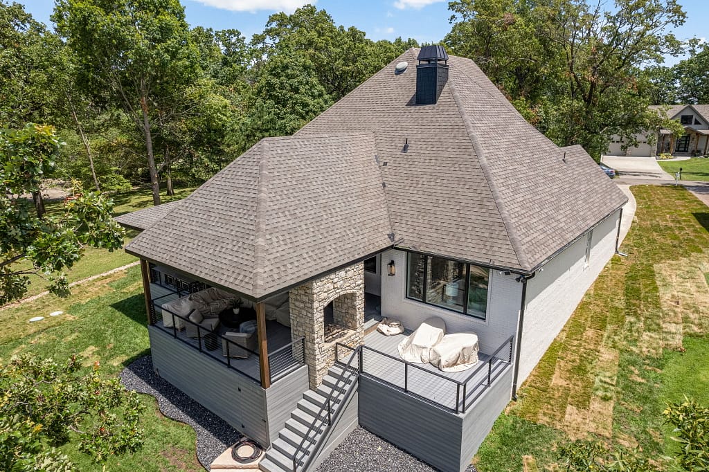 Modern home with large back deck and outdoor fireplace after remodel