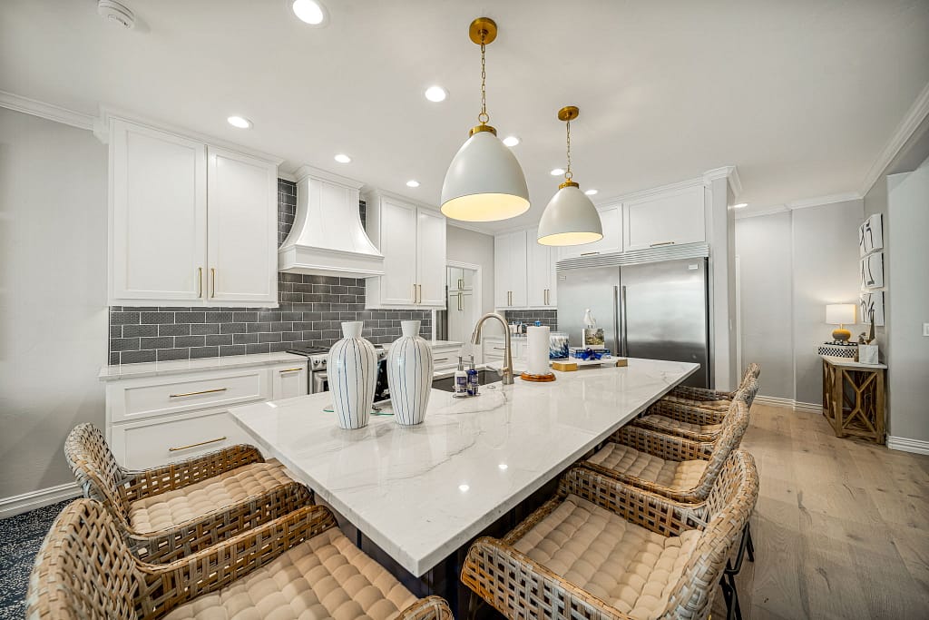 Large modern kitchen with large island and bar seating after remodel