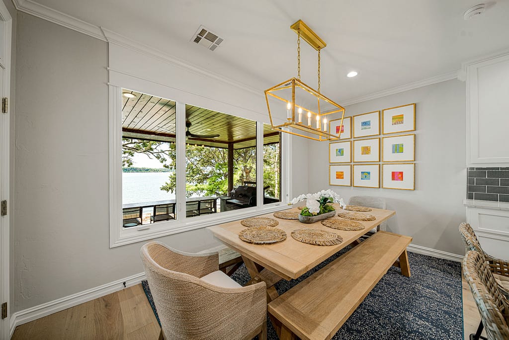 Modern dining room with large windows and gold accents