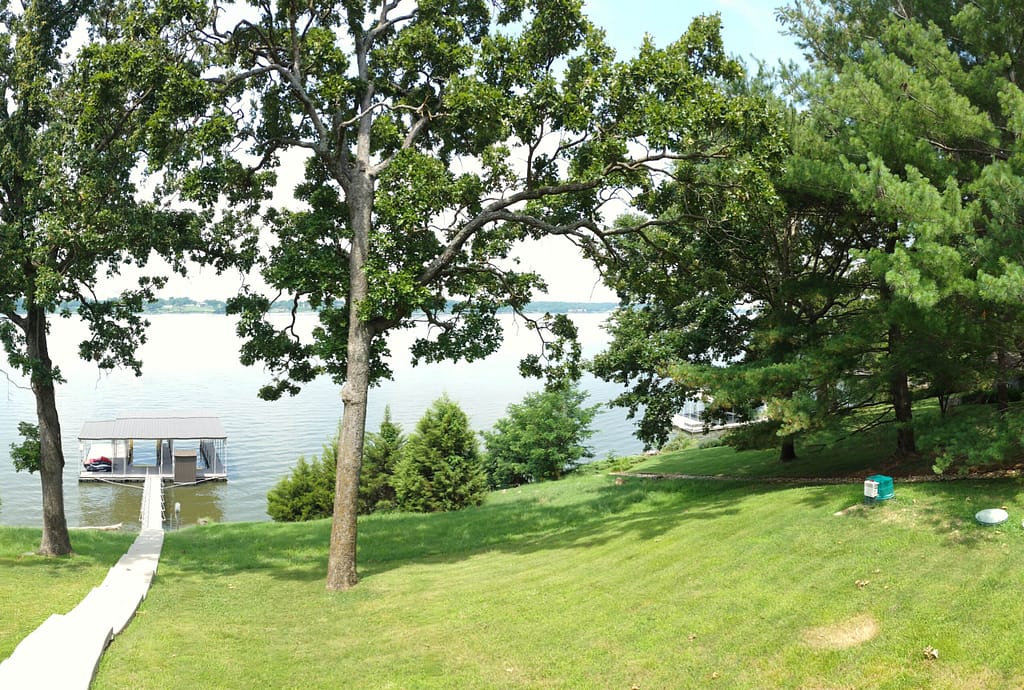 Backyard with lake view and boat dock before remodel