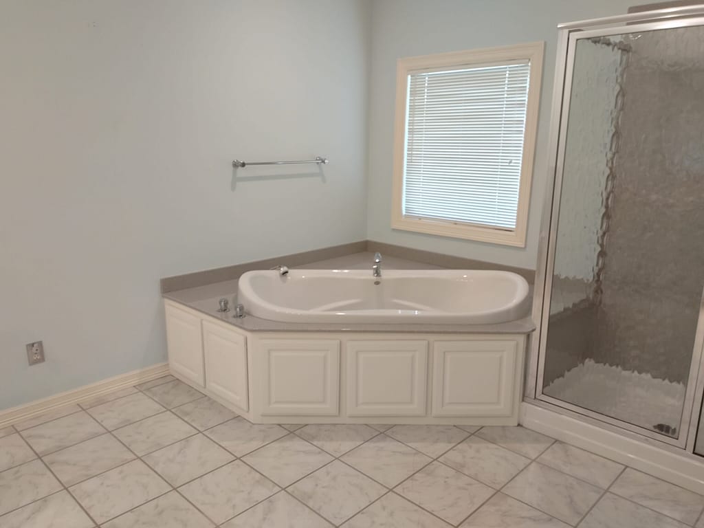 Master bath with large tub and shower before remodel
