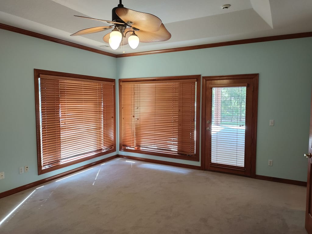 Master bedroom with windows and exterior door before remodel