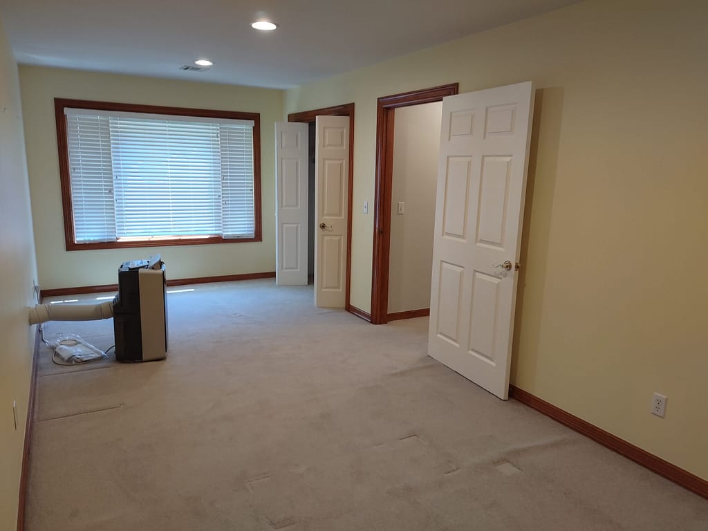 Bedroom with large window at the end before remodel