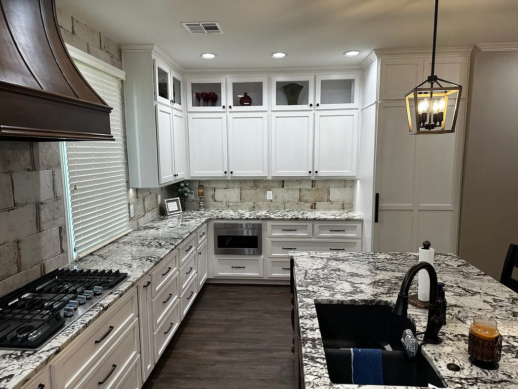 Kitchen with granite countertops and white cabinets after remodel