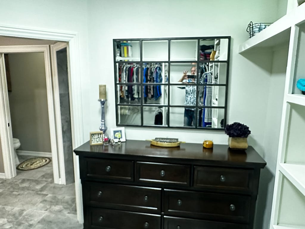 Closet with dresser and mirror after remodel