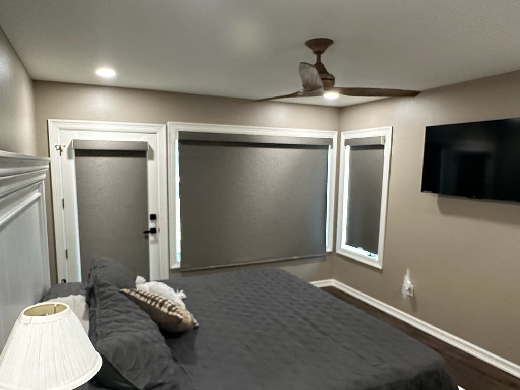 Bedroom with windows and exterior door after remodel