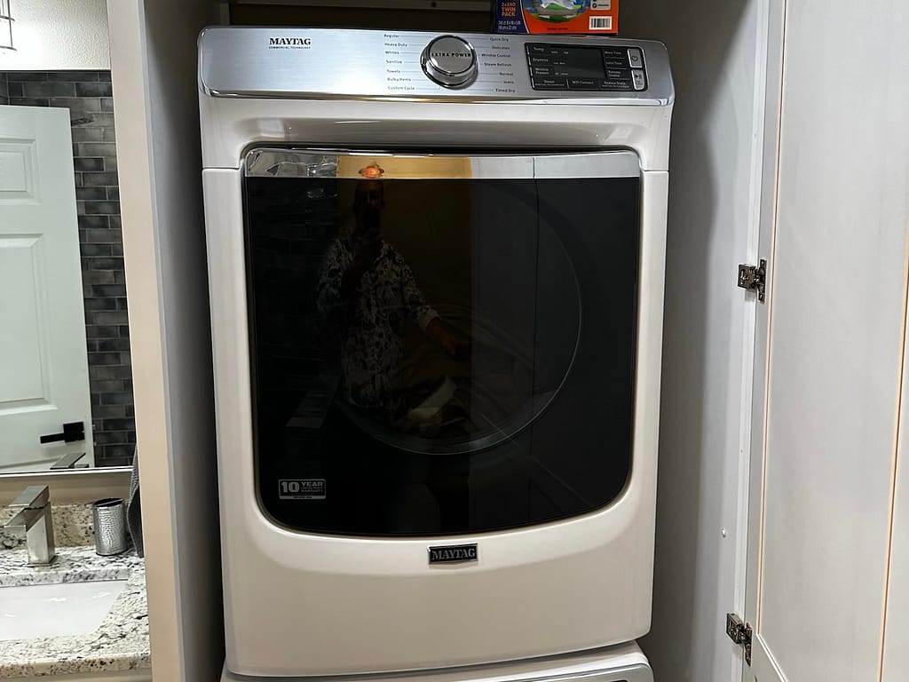 Stacked laundry unit in bathroom after remodel
